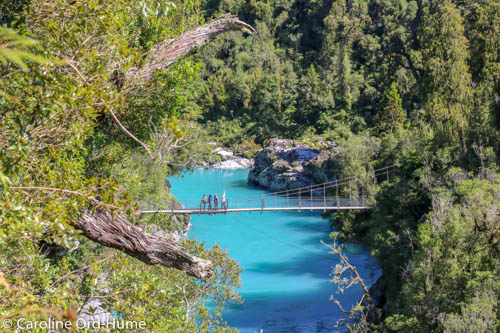 Aerial view of Hokitika Gorge turquoise water and swing bridge, West Coast, New Zealand
